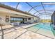 Inviting screened-in pool area with ample seating, a pool table, and outdoor entertainment options at 11014 Rustic Timber Loop, San Antonio, FL 33576