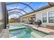 Luxury pool featuring a spa and beautiful views under a screened enclosure and covered patio at 11014 Rustic Timber Loop, San Antonio, FL 33576