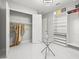 Spacious walk-in closet with custom shelving, drawers, glass table, and modern lighting at 11014 Rustic Timber Loop, San Antonio, FL 33576