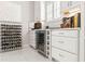 Chic wine storage area with built-in wine cooler and custom cabinetry, perfect for the wine enthusiast at 11014 Rustic Timber Loop, San Antonio, FL 33576