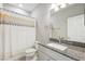 Bathroom featuring granite countertop and a shower curtain at 1103 Coral Ln, Dunedin, FL 34698