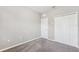 Simple bedroom with neutral walls, carpeting, and closet at 1103 Coral Ln, Dunedin, FL 34698
