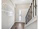 Entryway features wood-look tile flooring and decorative stair railing at 1103 Coral Ln, Dunedin, FL 34698
