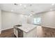 Bright kitchen featuring stainless appliances, granite countertops, pendant lighting, a large island and tile flooring at 1103 Coral Ln, Dunedin, FL 34698