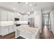 Bright kitchen featuring modern stainless appliances, granite countertops, pendant lighting, and a large kitchen island at 1103 Coral Ln, Dunedin, FL 34698