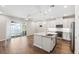Open-concept kitchen with stainless appliances, granite countertops, a spacious island, and access to an outdoor patio at 1103 Coral Ln, Dunedin, FL 34698