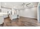 Open-concept kitchen featuring stainless appliances, granite countertops, a spacious island, and wood-look tile flooring at 1103 Coral Ln, Dunedin, FL 34698