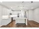 Bright kitchen featuring modern stainless appliances, granite countertops, pendant lighting, and a large kitchen island at 1103 Coral Ln, Dunedin, FL 34698