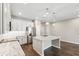 Bright kitchen featuring modern stainless appliances, granite countertops, pendant lighting, and a large kitchen island at 1103 Coral Ln, Dunedin, FL 34698