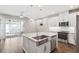 Modern kitchen features an island sink, stainless appliances, and granite countertops at 1103 Coral Ln, Dunedin, FL 34698