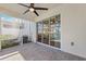 Relax on the brick-paved screened lanai with ceiling fan and view to the kitchen at 1103 Coral Ln, Dunedin, FL 34698