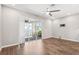 Spacious living room includes wood-look tile flooring and sliding glass door to the lanai at 1103 Coral Ln, Dunedin, FL 34698