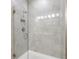 Contemporary tiled shower featuring glass doors and modern fixtures at 1103 Coral Ln, Dunedin, FL 34698