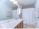 Bright bathroom with a large mirror, double sinks, and a shower at 11231 Spring Point Cir, Riverview, FL 33579