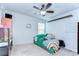 Cozy bedroom with a black metal bed frame and a ceiling fan at 11231 Spring Point Cir, Riverview, FL 33579