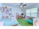 Fun bedroom with a geometric carpet, a single bed, and a desk at 11231 Spring Point Cir, Riverview, FL 33579