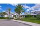 Exterior of the community clubhouse featuring lush landscaping, palm trees, and a welcoming entrance at 11231 Spring Point Cir, Riverview, FL 33579