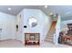 The home's entryway features a neutral color palette, decorative mirror and console, and a staircase at 11231 Spring Point Cir, Riverview, FL 33579