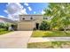 Two-story home featuring a well-manicured lawn, a two car garage, and neutral colored siding at 11231 Spring Point Cir, Riverview, FL 33579