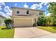 Two-story home with manicured lawn, neutral siding, and a two car garage at 11231 Spring Point Cir, Riverview, FL 33579