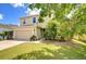 Two-story home with well-kept lawn, two-car garage, and tidy landscaping at 11231 Spring Point Cir, Riverview, FL 33579