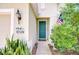 Up close, the home's front door is accented by a themed plaque, snake plants, and a decorative dog at 11231 Spring Point Cir, Riverview, FL 33579