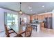Open kitchen and dining area featuring stainless steel appliances, granite counters, and sliding glass doors to the backyard at 11231 Spring Point Cir, Riverview, FL 33579