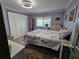 Serene bedroom with closet, floral bedding, and serene hues evoke feelings of comfort and relaxation at 121 Dolphin S Dr, Oldsmar, FL 34677