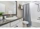 Bathroom featuring a shower/tub combo, granite vanity, and wood look tile flooring at 13121 Pasture View Loop, Riverview, FL 33579