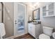 Well lit half bath featuring a granite vanity and outdoor access at 13121 Pasture View Loop, Riverview, FL 33579