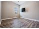 Bright and airy bedroom with wood flooring, neutral paint, and a large window at 13121 Pasture View Loop, Riverview, FL 33579