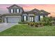 Charming two-story home with a well-manicured lawn, a two-car garage, and a tile roof at 13121 Pasture View Loop, Riverview, FL 33579