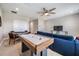 Upstairs game room with an air hockey table, comfortable seating, and ample lighting at 13121 Pasture View Loop, Riverview, FL 33579