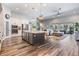 Open concept living space connecting the kitchen and living room, featuring a large island, stainless steel appliances, and cozy seating at 13121 Pasture View Loop, Riverview, FL 33579