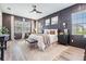 Luxurious main bedroom featuring elegant wood paneling, modern decor, and large windows for abundant natural light at 13121 Pasture View Loop, Riverview, FL 33579