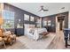 Stylish main bedroom showcasing elegant wood paneling, modern furniture, and plenty of natural light from large windows at 13121 Pasture View Loop, Riverview, FL 33579