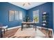Blue office with a wood desk, decor, and plank floors at 13121 Pasture View Loop, Riverview, FL 33579