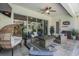 Inviting covered patio with stylish seating, a ceiling fan, and outdoor entertaining space at 13121 Pasture View Loop, Riverview, FL 33579