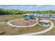 Aerial view of a lakeside community playground with slides and swings at 13121 Pasture View Loop, Riverview, FL 33579