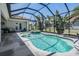 Sparkling in-ground pool with a hot tub, screened enclosure, and well-manicured landscaping at 13121 Pasture View Loop, Riverview, FL 33579