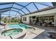 Relaxing outdoor living space includes a sparkling pool, spa, and comfortable seating area at 13121 Pasture View Loop, Riverview, FL 33579