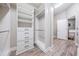 Walk-in closet with a custom shelving system and built-in drawers at 13121 Pasture View Loop, Riverview, FL 33579