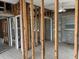 Renovation project shows a living room with exposed studs, hardwood floor and block walls ready for customization at 13200 Boca Ciega Ave, Madeira Beach, FL 33708