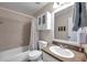 Standard bathroom with a shower-tub combo, matching toilet, and a sink with ample counter space at 13308 Kearney Way, Tampa, FL 33626