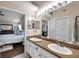 Bathroom featuring double sinks, vanity and a mirror, plus a view of the bedroom at 13308 Kearney Way, Tampa, FL 33626