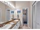 Bright bathroom featuring double sinks, neutral countertops, and a large mirror at 13308 Kearney Way, Tampa, FL 33626
