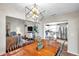 Open floor plan featuring a dining room with a decorative chandelier and hardwood table with chairs at 13308 Kearney Way, Tampa, FL 33626
