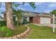 Charming single-story home with manicured lawn, lush landscaping, and a two-car garage at 13308 Kearney Way, Tampa, FL 33626