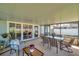 Screened-in porch featuring a dining table, chair, and tiled floors with views of the backyard at 13308 Kearney Way, Tampa, FL 33626