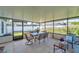 Screened in porch featuring a dining table, chair, and tiled floors at 13308 Kearney Way, Tampa, FL 33626